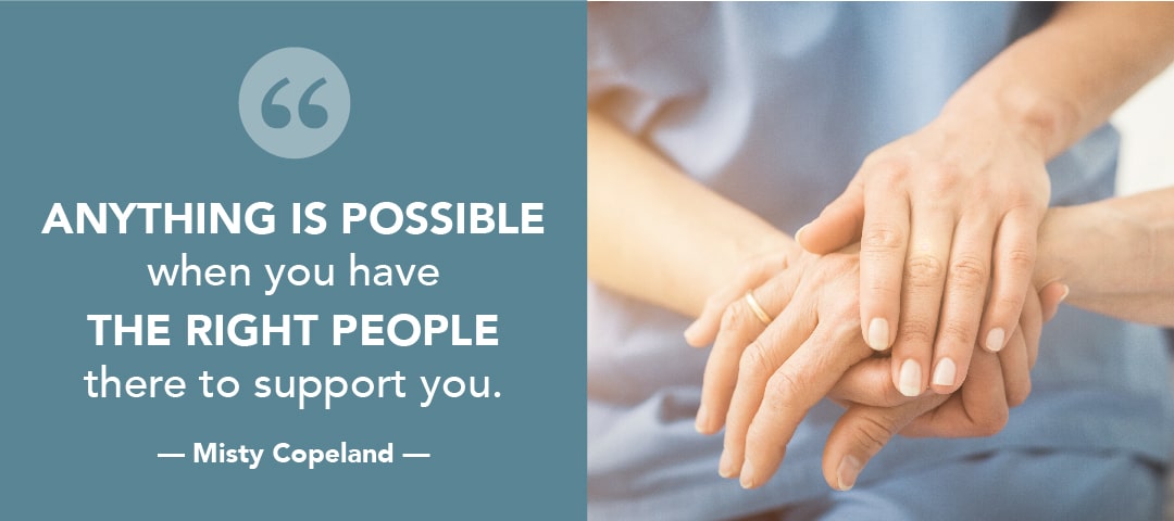 nurse holding patients hand