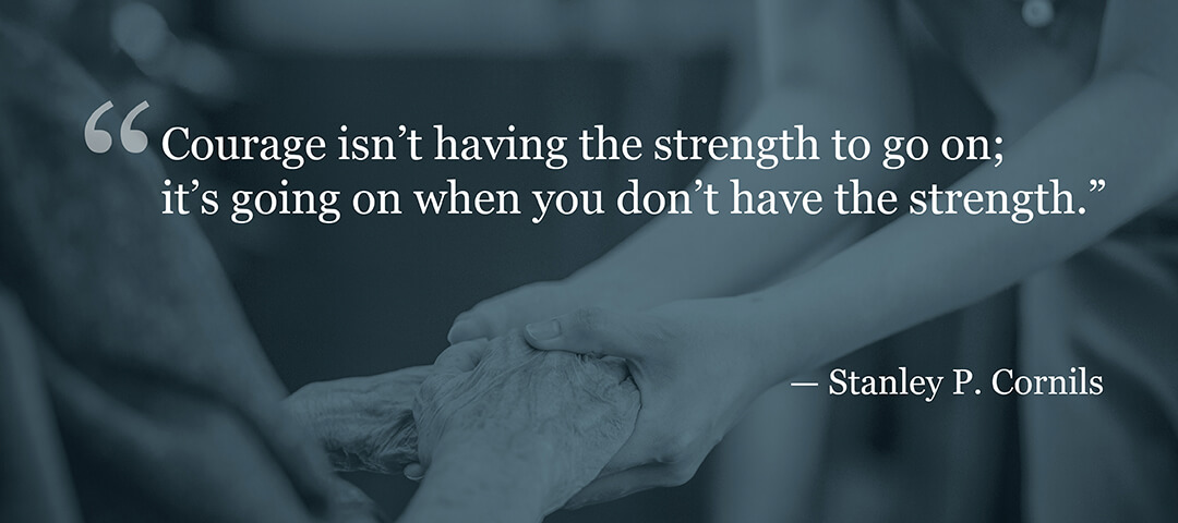 nurse holding hands with elderly patient