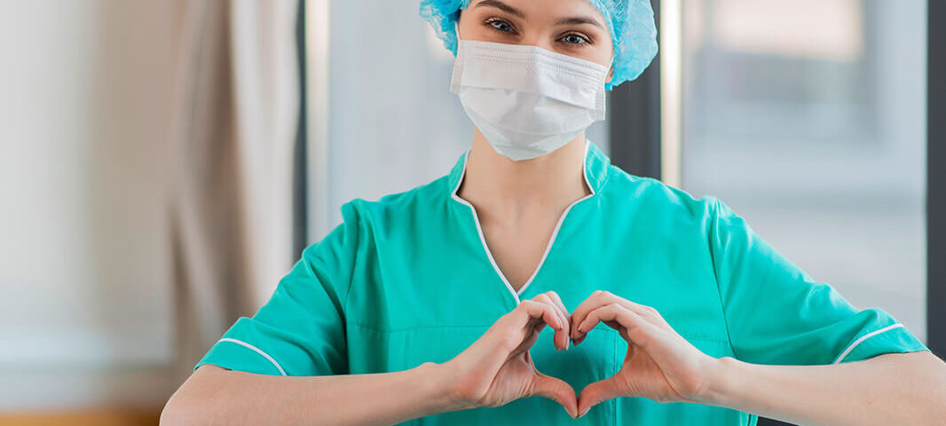 Nurse making a heart shape with her hands